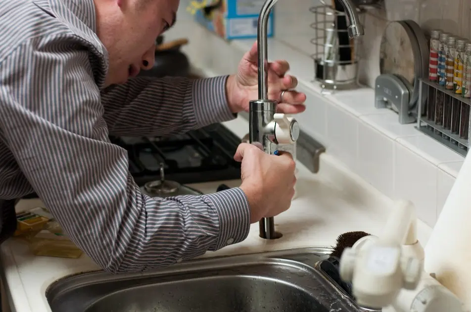 Licensed plumber working on a residential repair